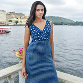 Meet Tarasha by The Sootee — a hand block printed indigo cotton dress featuring playful polka dots and crisp stripes. With a wrap-style V-neckline, fitted silhouette, and side pockets, this artisan-crafted piece blends timeless charm with modern slow-fashion elegance.