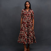 Discover Amaya by The Sootee — a flowing Bagru hand block print cotton dress with a collared tiered A-line silhouette, puffed half sleeves, and earthy floral motifs. Lightweight and breathable, this sustainable slow-fashion piece blends heritage craft with effortless elegance.
