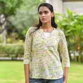 Discover Bloomfield by The Sootee — a hand block printed floral cotton top with a V-neckline, full sleeves, and side slits. Light, breathable, and artisan-made, this versatile piece blends everyday comfort with timeless feminine charm.