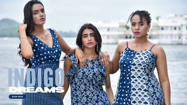 Three women wearing blue and white patterned dresses with 'Indigo Dreams' text.