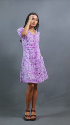 Meet Jamuntini by The Sootee — a purple Shibori cotton dress with a V-neckline, puff sleeves, wooden buttons, and side pockets. Hand-dyed and fully lined for comfort, this sustainable slow-fashion piece combines artisanal craft with playful vintage elegance.