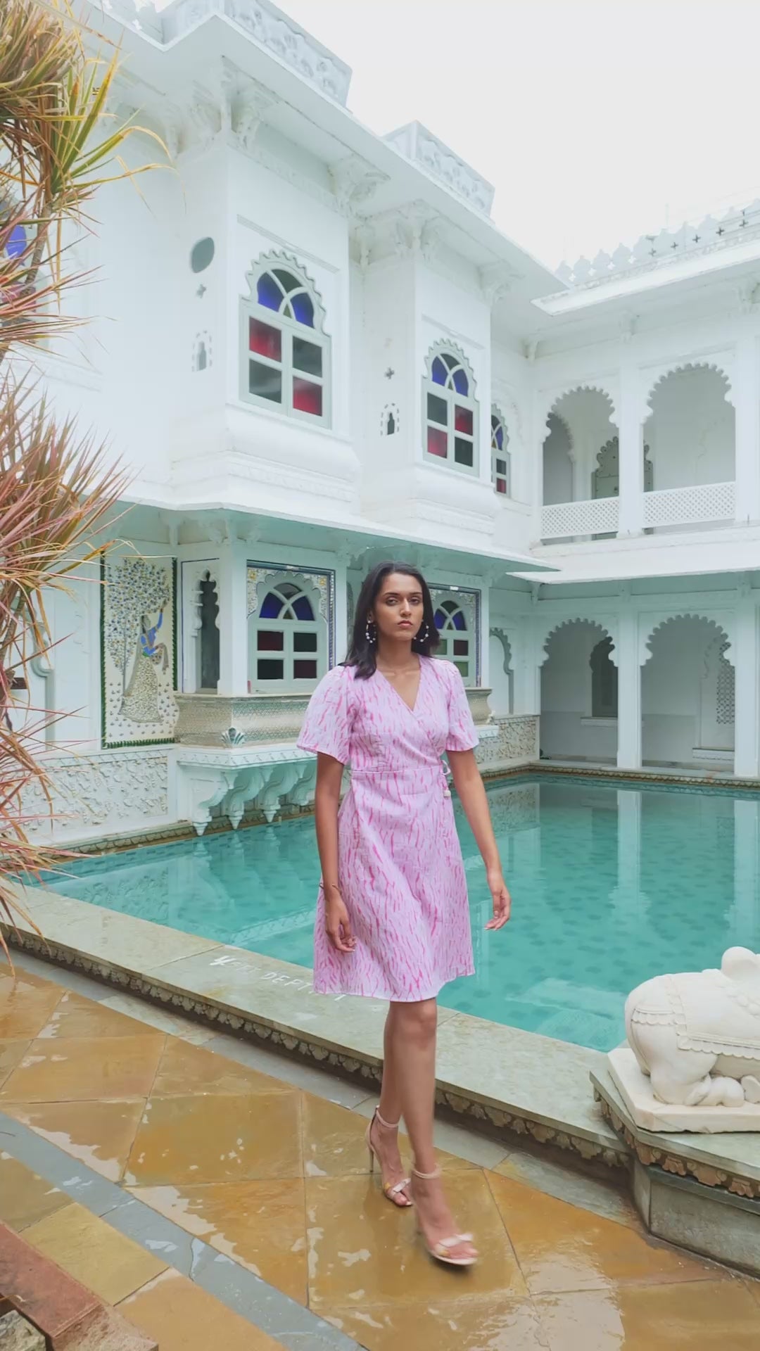 Discover Candy Floss by The Sootee — a pink Shibori cotton wrap dress with a V-neckline, flutter sleeves, and side pockets. Hand-dyed and fully lined, this artisanal slow-fashion piece blends playful charm with effortless feminine sophistication.